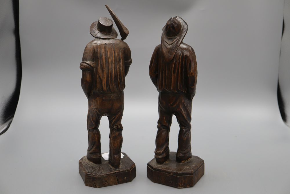 Two carved wood figures of workmen, with ivory faces, signed Neri, height 31cm